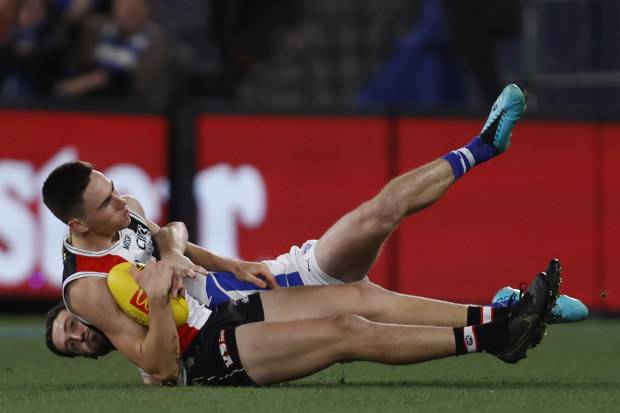 MELBOURNE, AUSTRALIA - JULY 23: Lachie Young of the Kangaroos tackles Cooper Sharman of the Saints during the round 19 AFL match between St Kilda Saints and North Melbourne Kangaroos at Marvel Stadium, on July 23, 2023, in Melbourne, Australia. (Photo by Darrian Traynor/Getty Images)