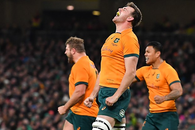 Nick Frost (middle) lets out a roar after the Wallabies score.
