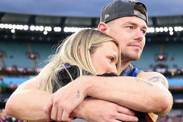 MELBOURNE, AUSTRALIA - SEPTEMBER 27: Lachie Neale of the Lions shares a moment with his wife Jules Neale after winning the AFL Grand Final match between Geelong Cats and Brisbane Lions at Melbourne Cricket Ground on September 27, 2025 in Melbourne, Australia. (Photo by Cameron Spencer/AFL Photos/via Getty Images)