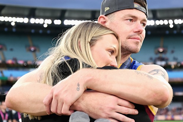 MELBOURNE, AUSTRALIA - SEPTEMBER 27: Lachie Neale of the Lions shares a moment with his wife Jules Neale after winning the AFL Grand Final match between Geelong Cats and Brisbane Lions at Melbourne Cricket Ground on September 27, 2025 in Melbourne, Australia. (Photo by Cameron Spencer/AFL Photos/via Getty Images)
