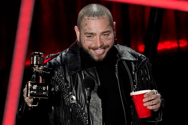 Post Malone accepts the top artist award at the Billboard Music Awards on Wednesday, Oct. 14, 2020, at the Dolby Theatre in Los Angeles. (AP Photo/Chris Pizzello)