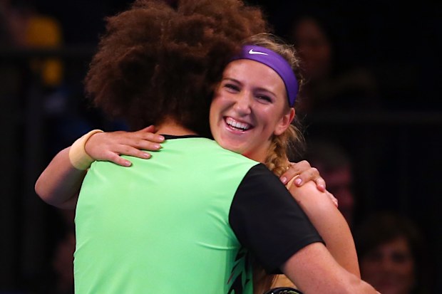 LMFAO singer Redfoo hugs Victoria Azarenka of Belarus during her match against Serena Williams of the USA the BNP Paribas Showdown on March 4, 2013 at Madison Square Garden in New York City. (Photo by Elsa/Getty Images)