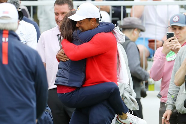 MELBOURNE, AUSTRALIA - DECEMBER 15:  Playing Captain Tiger Woods of the United States team celebrates with girlfriend Erica Herman after defeating Abraham Ancer of Mexico and the International team 3&2 during Sunday Singles matches on day four of the 2019 Presidents Cup at Royal Melbourne Golf Course on December 15, 2019 in Melbourne, Australia. (Photo by Warren Little/Getty Images)