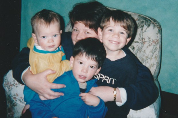 Jacob Boutcher with his mum Jodie and two elder brothers.