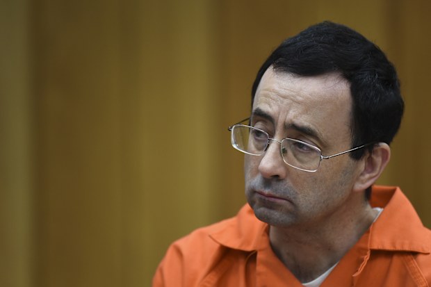 Larry Nassar listens as Rachael Denhollander gives her victim impact statement Friday, February 2, 2018. 