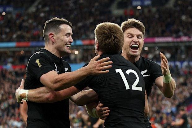 Jordie Barrett of New Zealand celebrates with Will Jordan and Beauden Barrett.