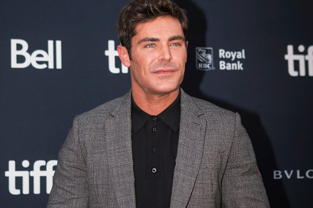 Zac Efron poses for a photograph on the red carpet for the film, "Greatest Beer Run Ever," at Roy Thomson Hall during the Toronto International Film Festival, 2022.