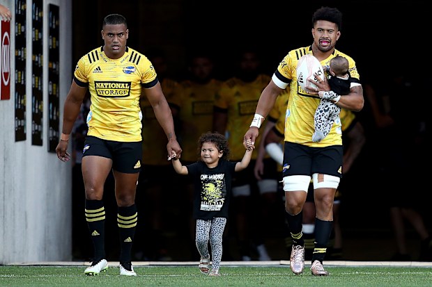 Ardie and Julian Savea of the Hurricanes walk out onto the ground at Sky Stadium.