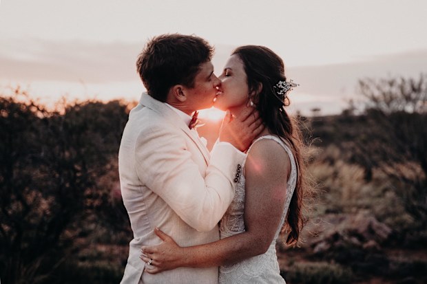 Newlyweds Lauren and Nick Jackson share a kiss.