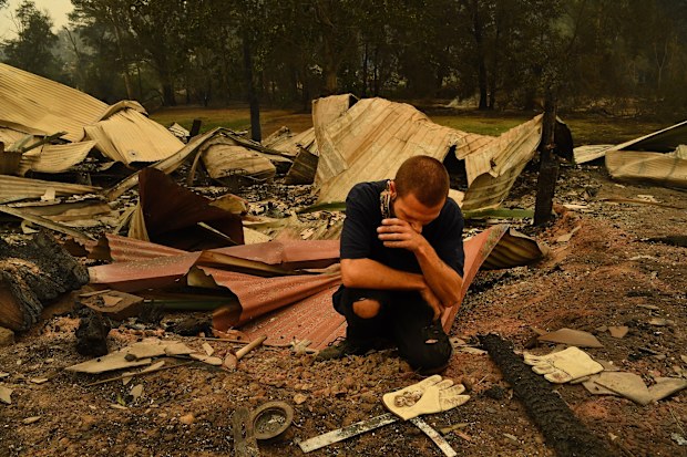 Karl Niehus unearths Water Dragon eggs from the ruins of his mother's business in Mogo's Main Street that was destroyed by the fire that swept through the town yesterday. Mogo, NSW. 1st January, 2020. 