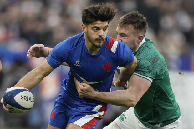 Romain Ntamack of France passes the ball as he is tackled by Ireland's Jack Conan during the Six Nations.