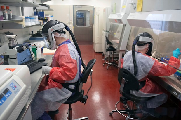 Researchers for the Center for Vaccine Research at the University of Pittsburgh, work with samples of the coronavirus.