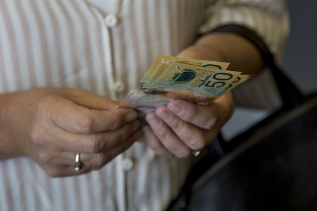 Woman holding Australian cash.