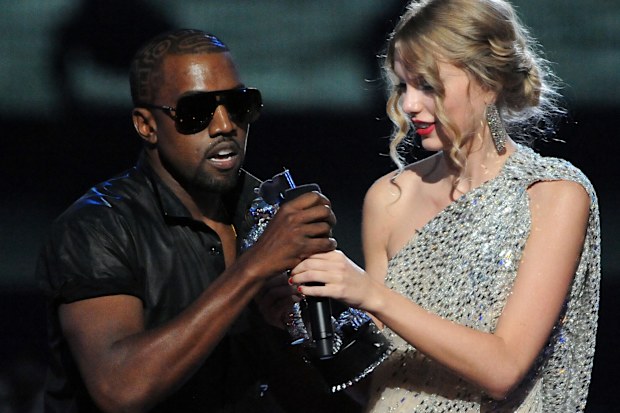 Kanye West jumps onstage as Taylor Swift accepts her award for the "Best Female Video" award during the 2009 MTV Video Music Awards at Radio City Music Hall on September 13, 2009 in New York City. 