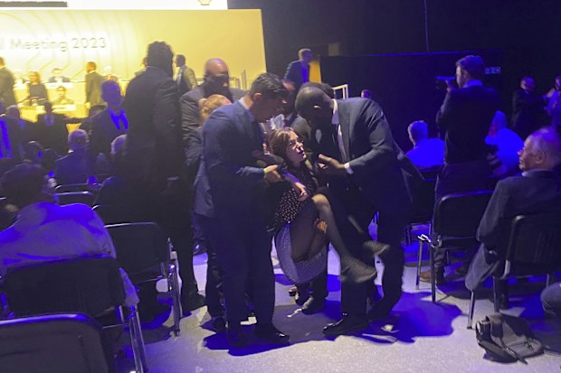 Protesters who tried to storm the stage are taken out of the Excel centre in east London during oil giant Shell's annual general meeting in London, Tuesday, May 23, 2023. 