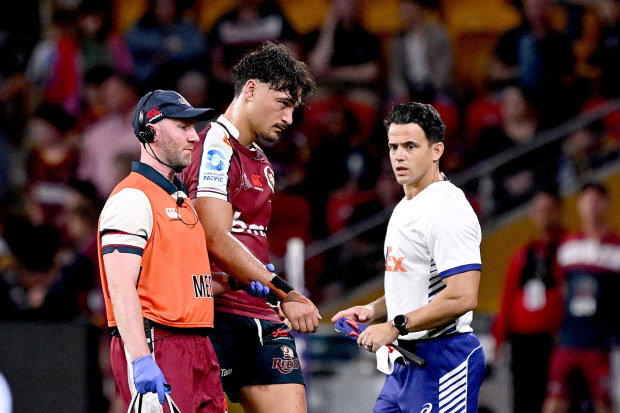 Jordan Petaia of the Reds is taken from the field injured during the round nine Super Rugby Pacific match against the Highlanders.