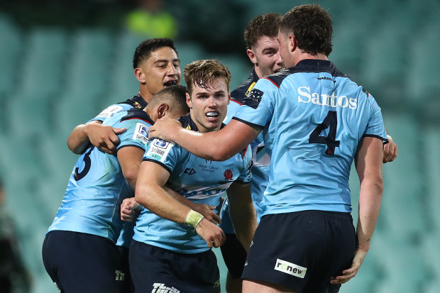 Will Harrison of the Waratahs celebrates scoring a try.