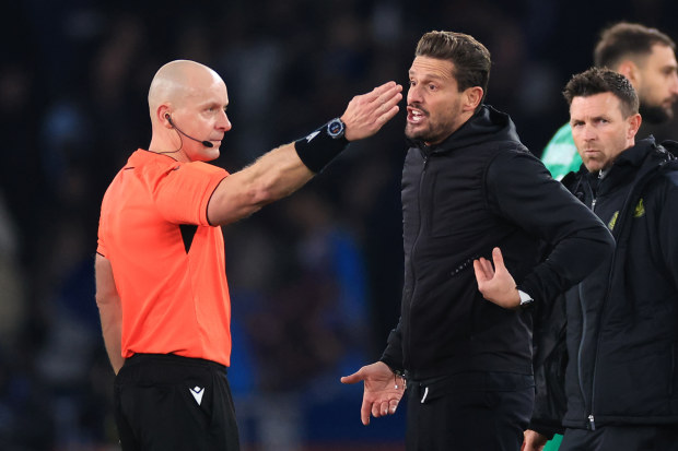 Newcastle United assistant Jason Tindall confronts referee Szymon Marciniak.