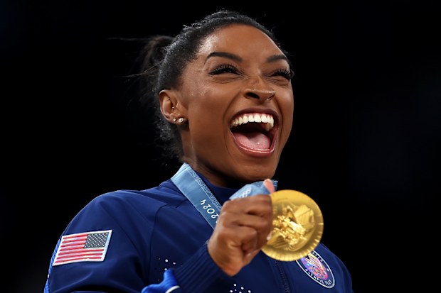 Gold medalist Simone Biles of Team United States celebrates on the podium.