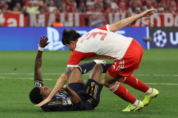 Bayern Munich's Minjae Kim brings down Real Madrid's Rodrygo in the penalty area, gifting the visitors a penalty kick.