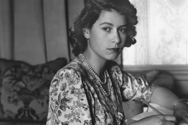 Queen Elizabeth II (as Princess Elizabeth) writing at her desk in Windsor Castle, Berkshire.  (Photo by Lisa Sheridan/Studio Lisa/Getty Images)