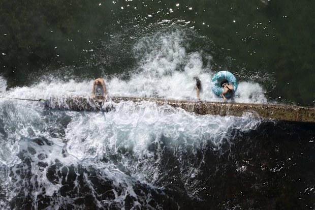 Swimmers cool off in Oak Park Rock Pool in Sydney on a scorching summer's day