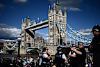 Members of the public stand in the queue near Tower Bridge, as they wait in line to pay their respects to the late Queen Elizabeth II, in London on September 16, 2022, who is lying-in-state at Westminster Abbey. - Queen Elizabeth II will lie in state until 0530 GMT on September 19, a few hours before her funeral, with huge queues expected to file past her coffin to pay their respects. (Photo by Marco BERTORELLO / AFP) (Photo by MARCO BERTORELLO/AFP via Getty Images)