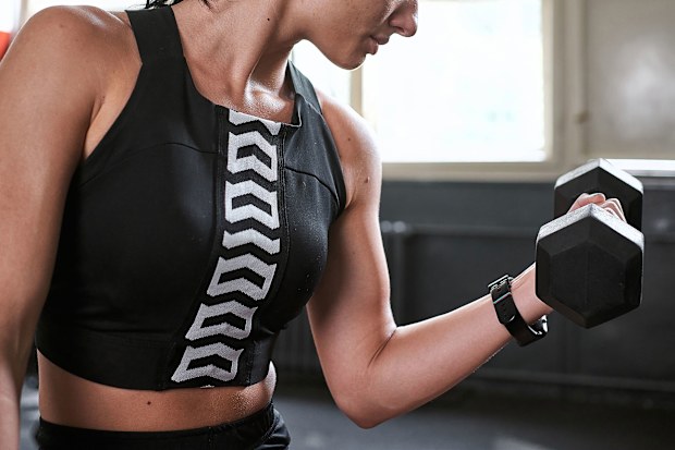 Woman lifting dumbbell in a gym
