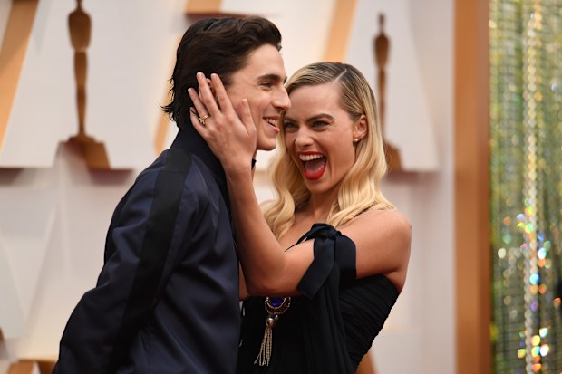 Timothee Chalamet, left, and Margot Robbie arrive at the Oscars on Sunday, Feb. 9, 2020, at the Dolby Theatre in Los Angeles