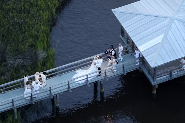 Jennifer Lopez wears a stunning white wedding dress as she celebrates her marriage to Ben Affleck, suitably dashing in a white jacket and black pants. The couple kissed and posed for pics around Bens $8million Georgia mansion on Saturday evening before spending the night celebrating their love and their union with family and a raft of A-list friends.
