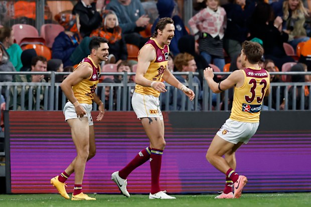 Joe Daniher of the Lions celebrates a goal with teammates during their semi final.