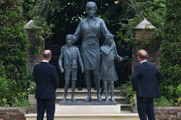 Britain's Prince William and Prince Harry look at the staue they commissioned of their mother Princess Diana,  on what woud have been her 60th birthday, in the Sunken Garden at Kensington Palace, London, Thursday July 1, 2021. (Dominic Lipinski /Pool Photo via AP)