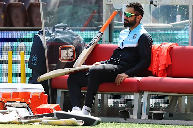 Virat Kohli of India watches play from the players bench.