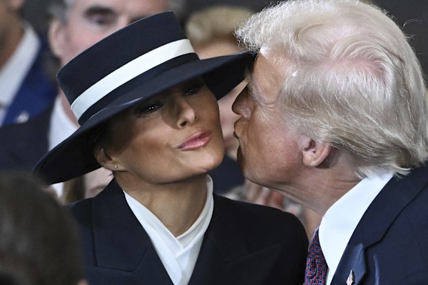 President-elect Donald Trump kisses Melania Trump before the 60th Presidential Inauguration in the Rotunda of the U.S. Capitol in Washington, Monday, Jan. 20, 2025. 