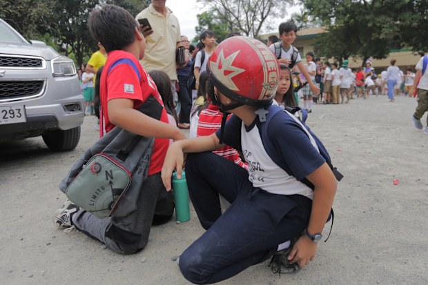 Children evacuate a school after a strong earthquake in Davao City, the Philippines on Friday Oct. 10, 2025.