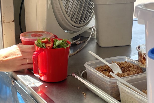 Two reusable plastic mugs filled with laksa in Darwin