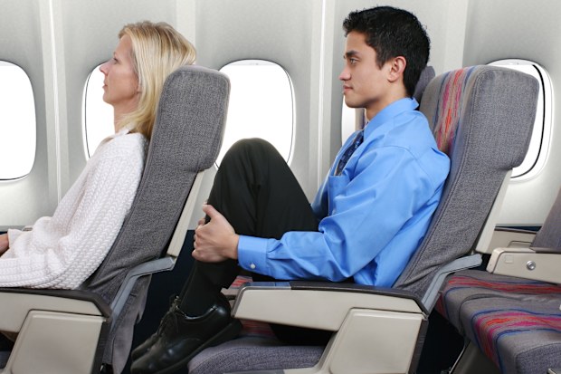Man with no leg room on flight