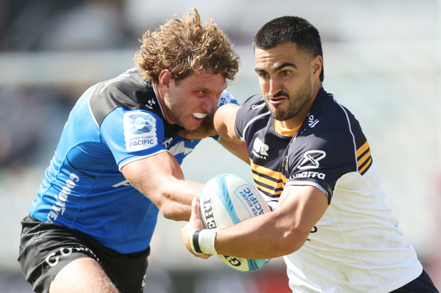 Tom Wright of the Brumbies is tackled by Bayley Kuenzle of the Force.