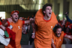 NUVOLA LAVAZZA, TURIN, ITALY - 2024/01/28: The 'Carota Boys' (a group of fans of Jannik Sinner dressed up as carrots) celebrate a point during an event organized at Nuvola Lavazza to watch live on a big screen the Australian Open Final between Jannik Sinner of Italy and Daniil Medvedev of Russia. Jannik Sinner won 3-6, 3-6, 6-4, 6-4, 6-3 claiming his first Grand Slam title. (Photo by Nicolò Campo/LightRocket via Getty Images)