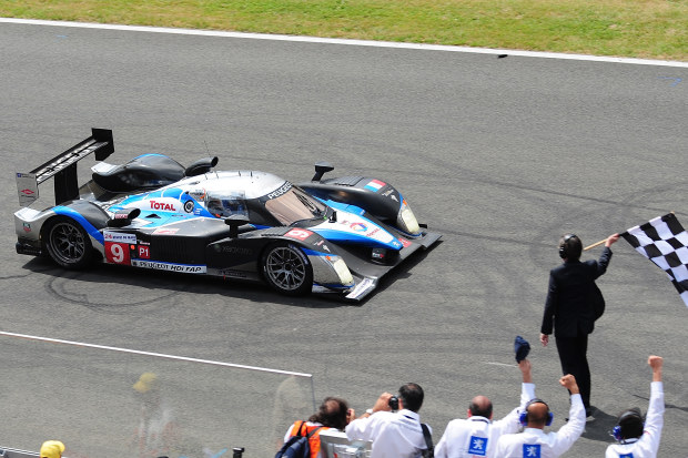 The No.9 Peugeot 908 takes the chequered flag at the end of the 2009 24 Hours of Le Mans.