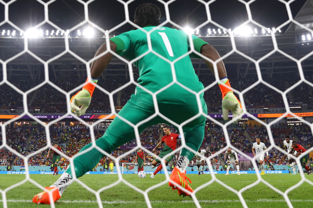 In this photo taken from a remote camera from behind the goal) Cristiano Ronaldo of Portugal coverts the penalty to score their team's first goal past Lawrence Ati Zigi of Ghana during the FIFA World Cup Qatar 2022 Group H match between Portugal and Ghana at Stadium 974 on November 24, 2022 in Doha, Qatar. (Photo by Richard Heathcote/Getty Images)