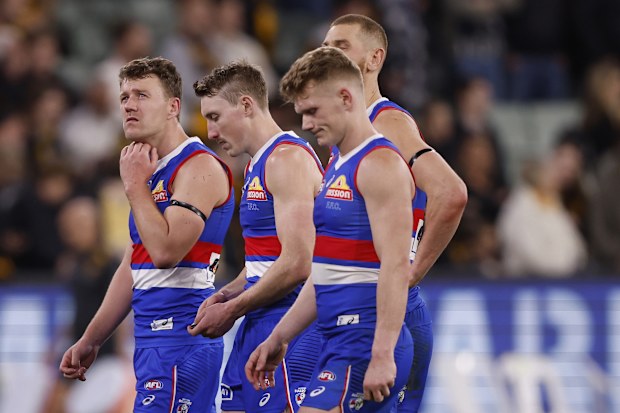 Disappointed Bulldogs players walk from the ground.