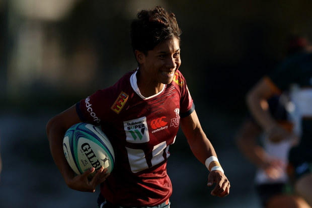 Heleina Young of the Reds runs in to score a try.