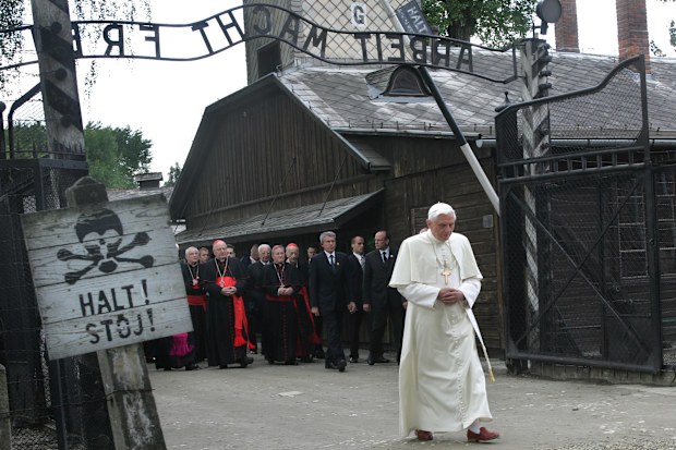 Pope Benedict XVI walks through the gate of the former Nazi concentration camp of Auschwitz, with sign above reading in German "Work will set you free", in Oswiecim, Poland, on May 28, 2006. 