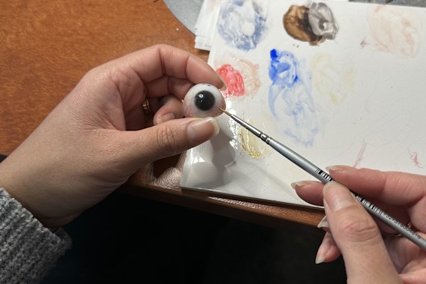 Emily Geelen paints a prosthetic eye at Artificial Eyes in West Perth.