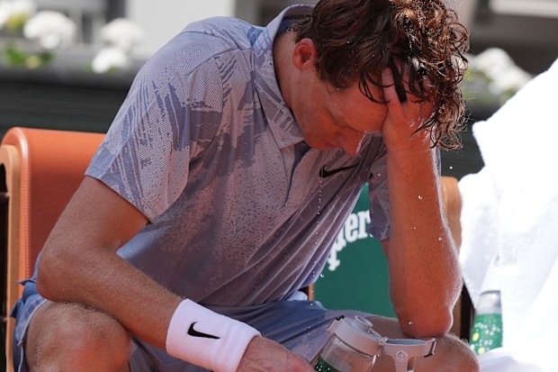 Jannik Sinner of Italy cools himself with the water during a break.