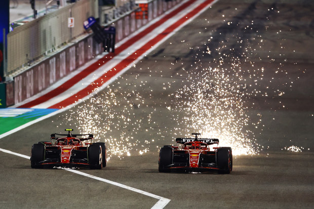 Sparks fly from the cars of Carlos Sainz and Charles Leclerc driving the Ferrari SF-24.