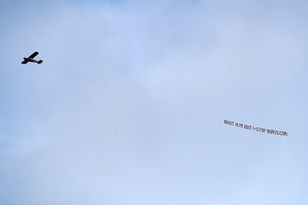 LEEDS, ENGLAND - JANUARY 22: A plane flies over the stadium with a message directed to UK Prime Minister Boris Johnson during the Premier League match between Leeds United and Newcastle United at Elland Road on January 22, 2022 in Leeds, England. (Photo by George Wood/Getty Images)