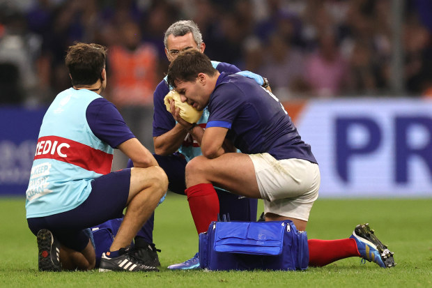 Antoine Dupont, the France captain, receives treatment following head contact with Johan Deysel.
