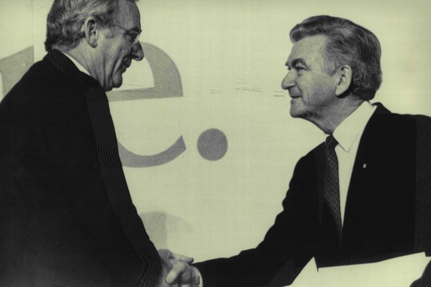 Bill Hayden holds Bob Hawke's hand after Mr. Hawke Praised Mr. Hayden in his speech today in Hobart. July 9, 1986.